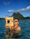 Brian Smith 1977 Ames High School Alum in the water shooting with an 8x10 camera at Bora Bora